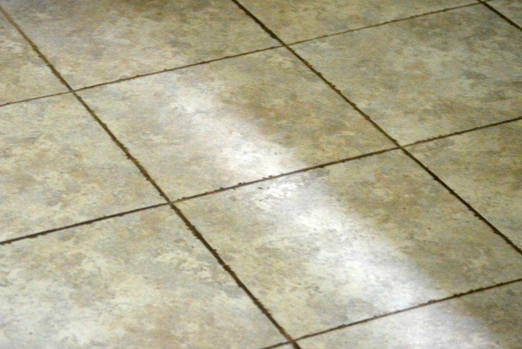 dirty tile floor before being cleaned with eco-friendly DIY grout cleaner