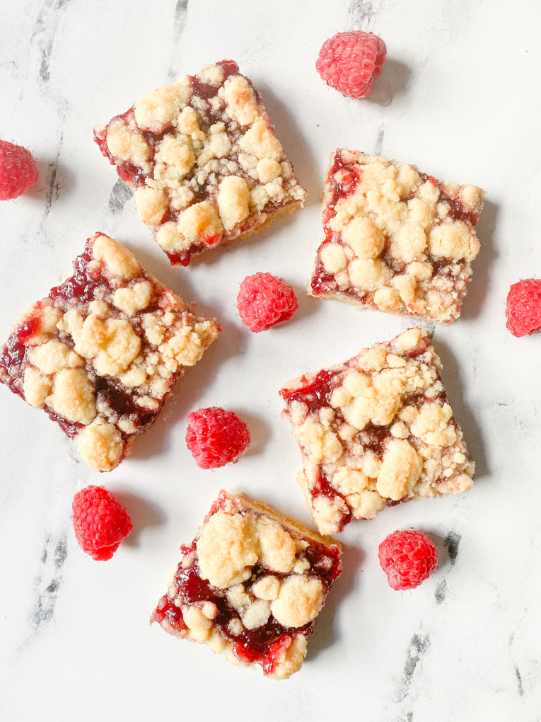 flatlay of raspberry bars on marble counter