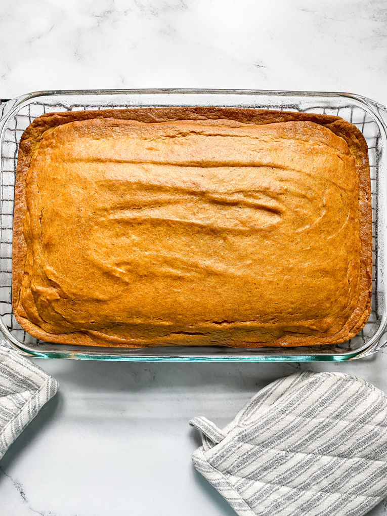 baking dish with baked pumpkin bars cooling on cooling rack