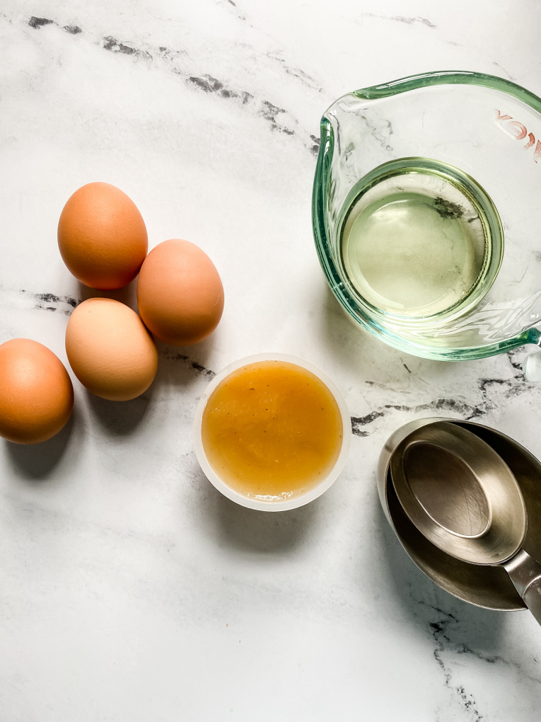 view of eggs, vegetable oil, applesauce and measuring cups