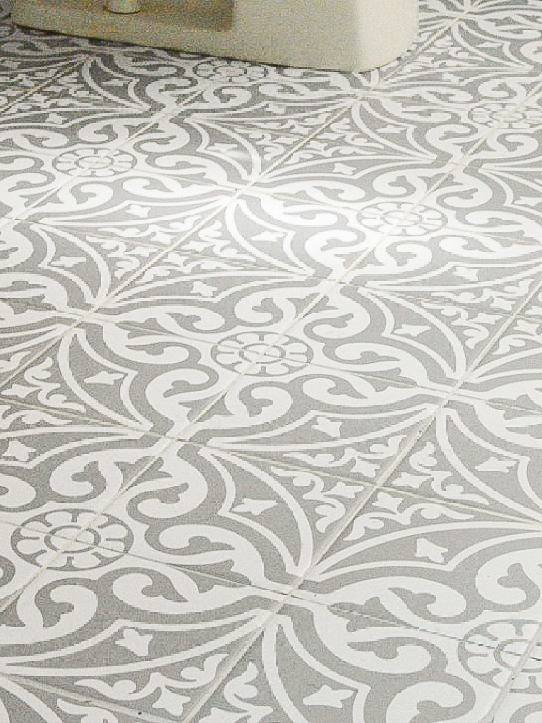 view of bathroom floor with tile stickers