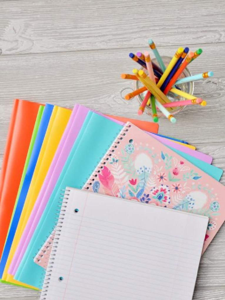 school supplies: folders, notebooks, and colored pencils