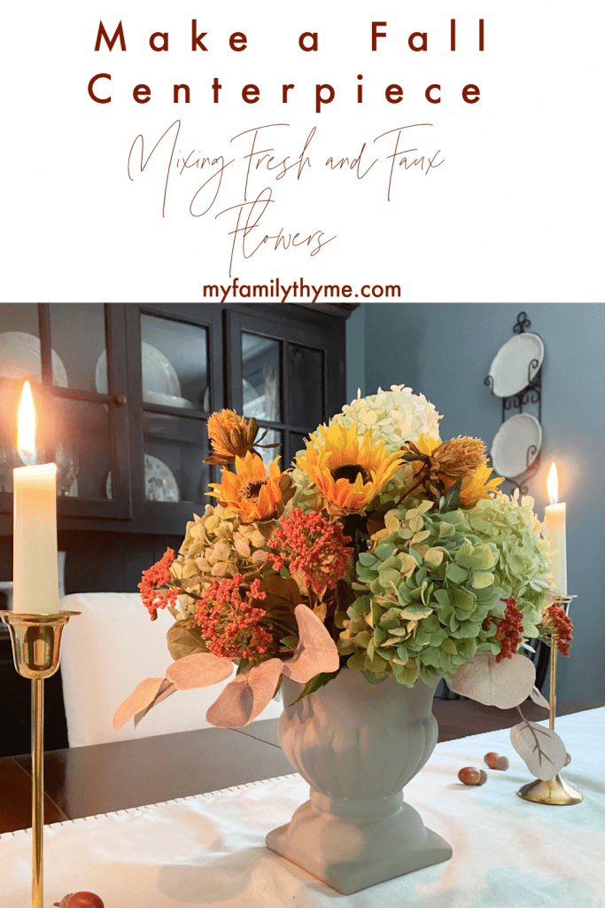view of fall centerpiece in dining room made with fresh and faux flowers