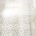 view of bathroom floor with tile stickers
