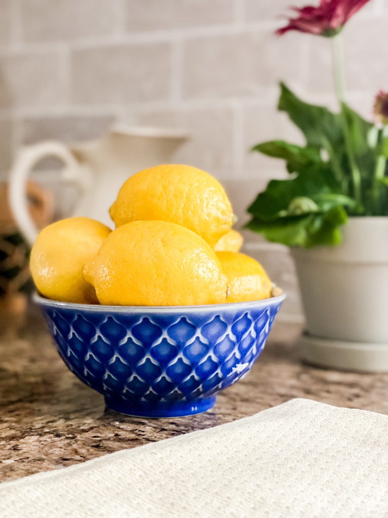 view of lemons, plants, and yellow towel