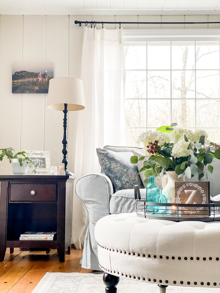 sharing spring decorating ideas with view of couch, ottoman, and side table.