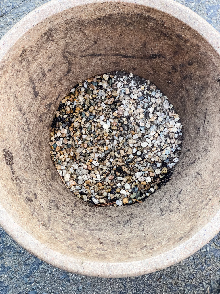 pea gravel in the bottom of the flower garden container, before adding soil