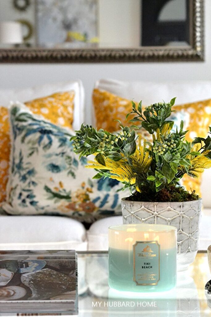 Hubbard Home's view of couch with yellow and blue pillows