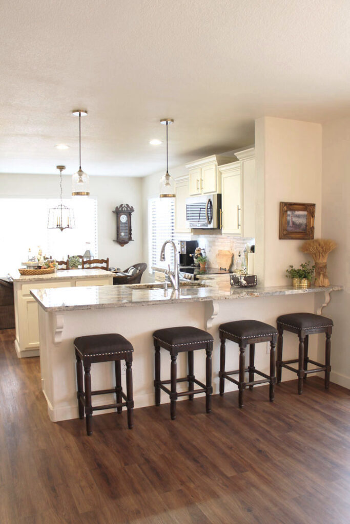 photo of recently updated kitchen with white cabinets and granite countertops