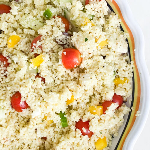mediterranean couscous salad with cucumber, tomatoes, yellow peppers, kalamata olives, and feta cheese.