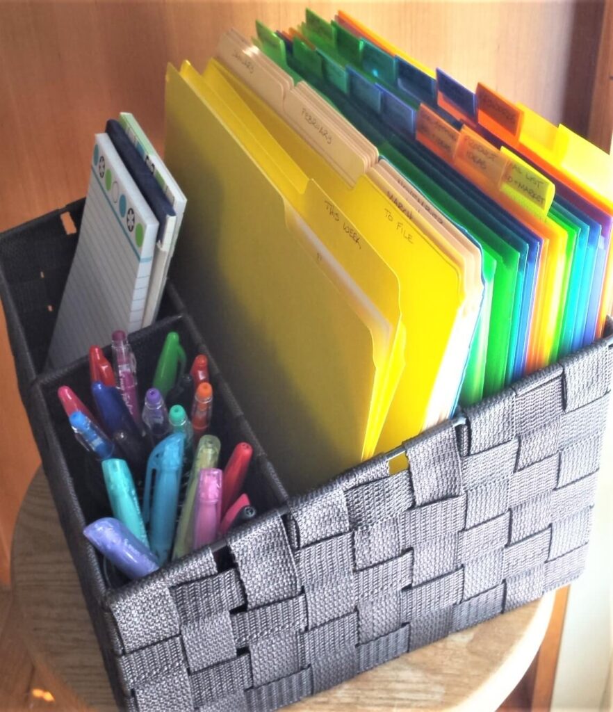 basket of colorful organized files and colored pens