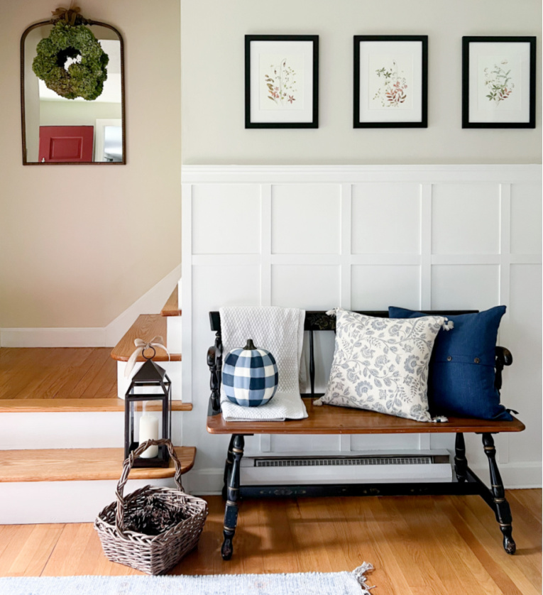 entryway with board and batten wall and bench decorated with blue and white for fall