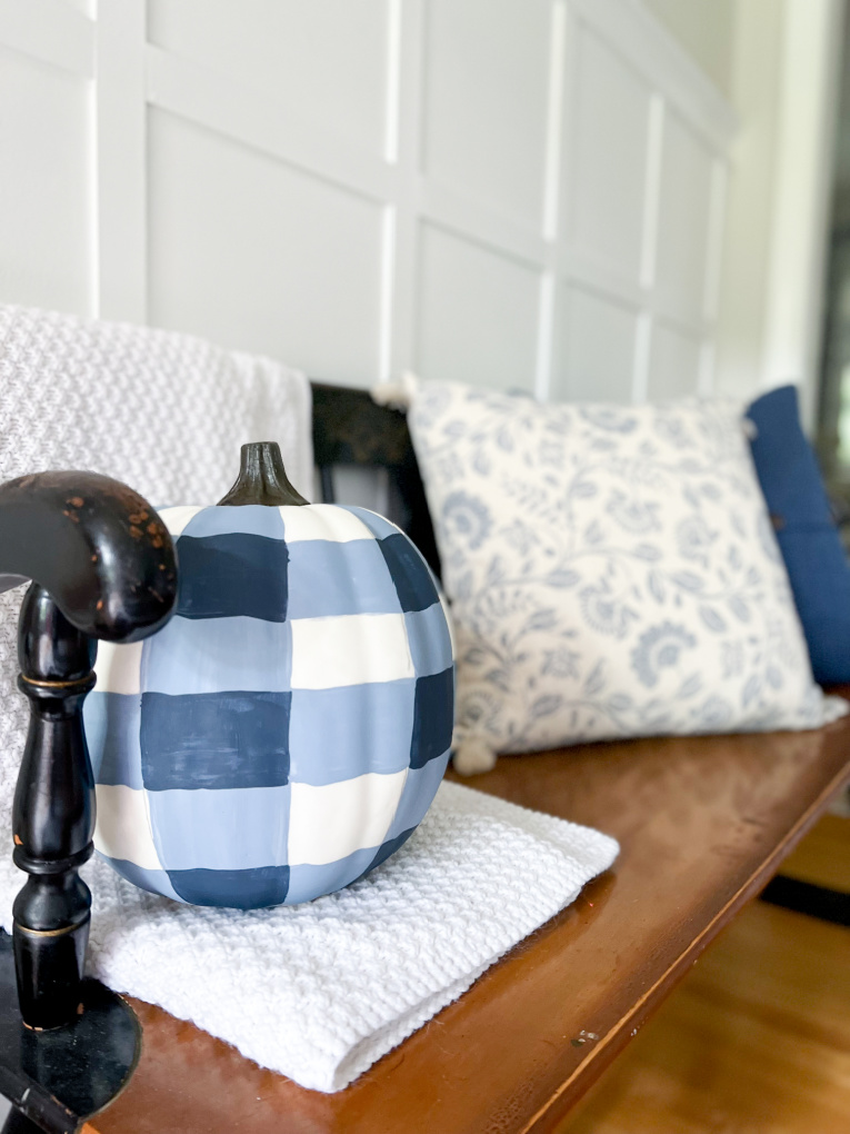 gingham painted pumpkin finished on bench in fall decorated entryway