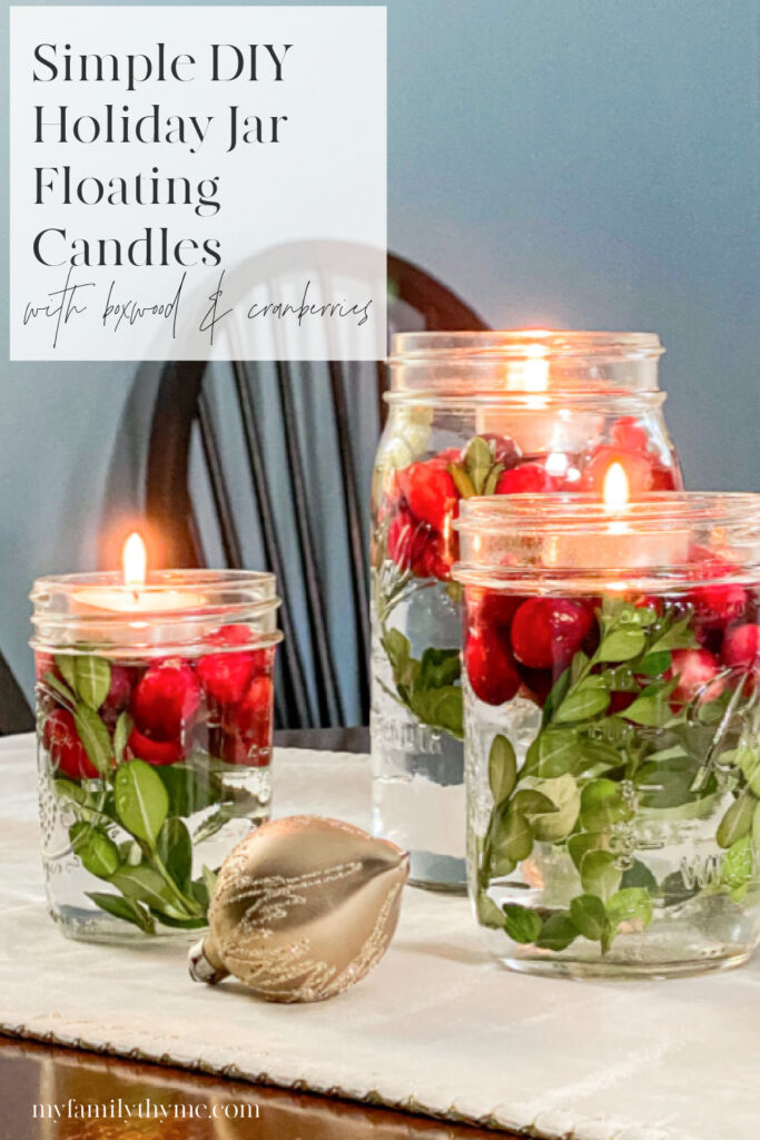 3 DIY Holiday Jar Floating Candles with Boxwood and Cranberries on runner with gold vintage ornaments