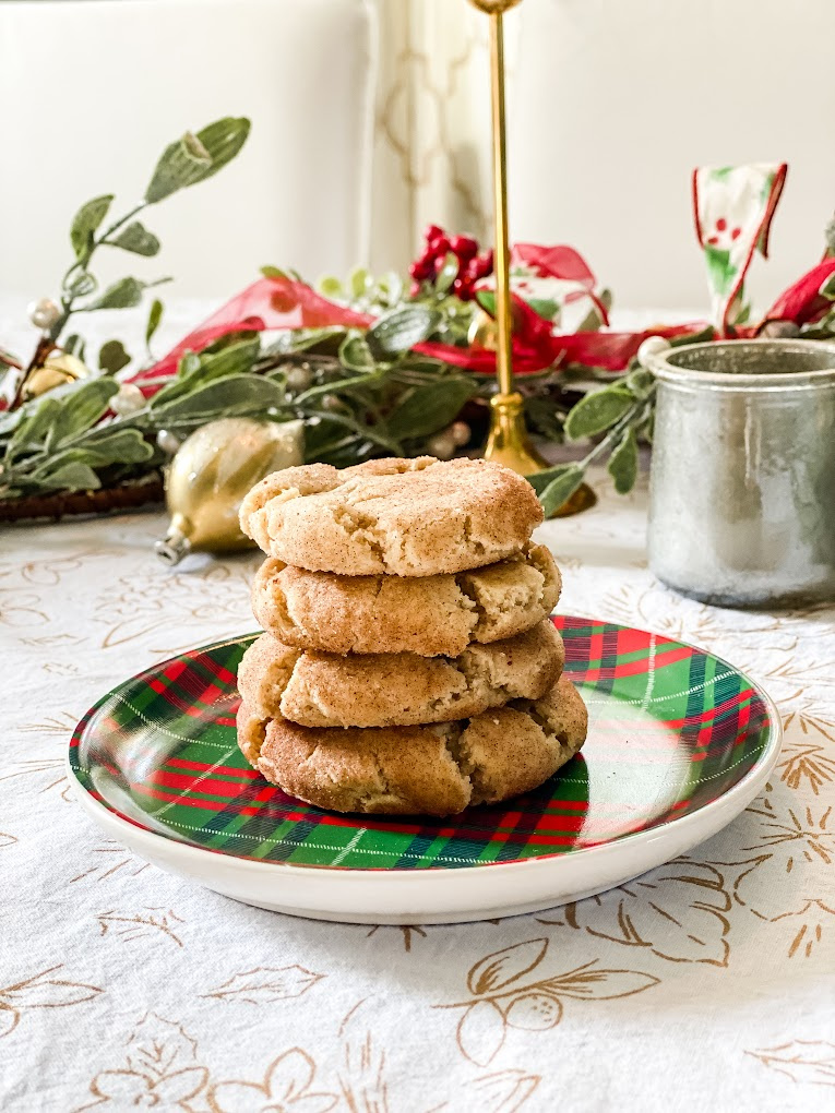 stack of four eggnog snickerdoodle cookies on a plaid plate