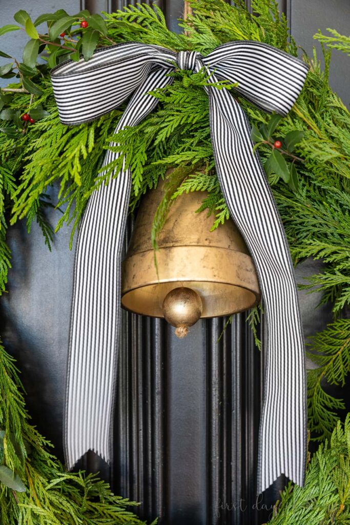 diy winter wreath with bell on front door