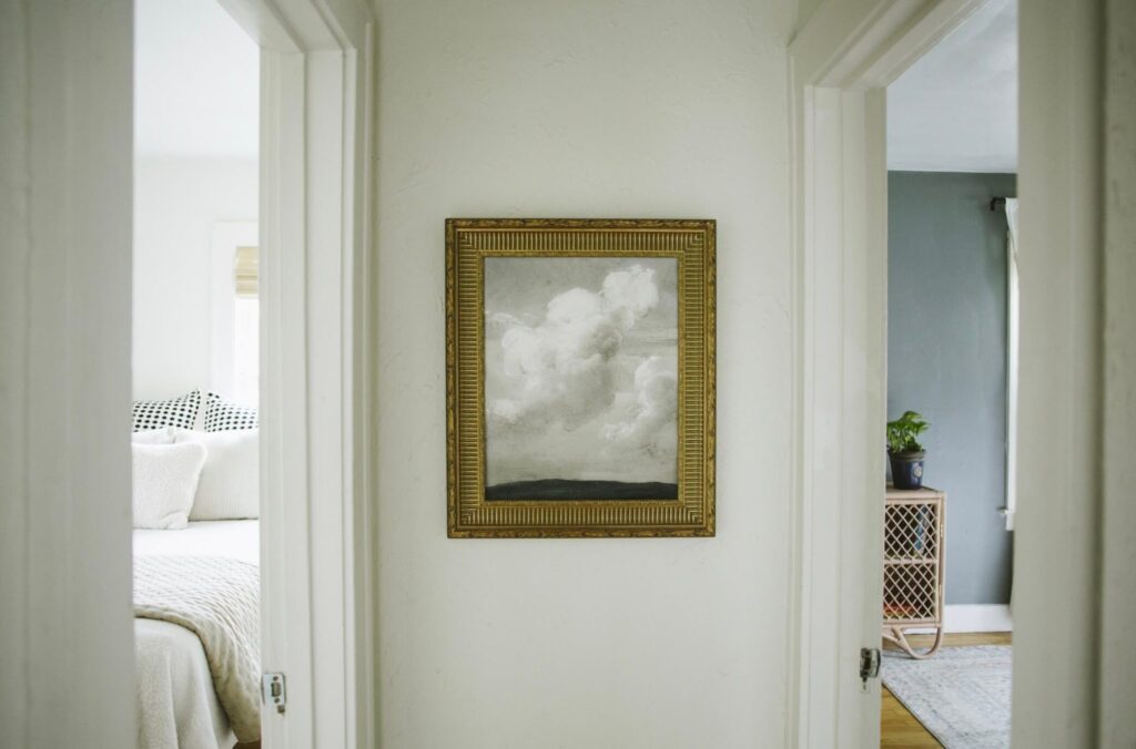 hallway with framed cloud print on wall