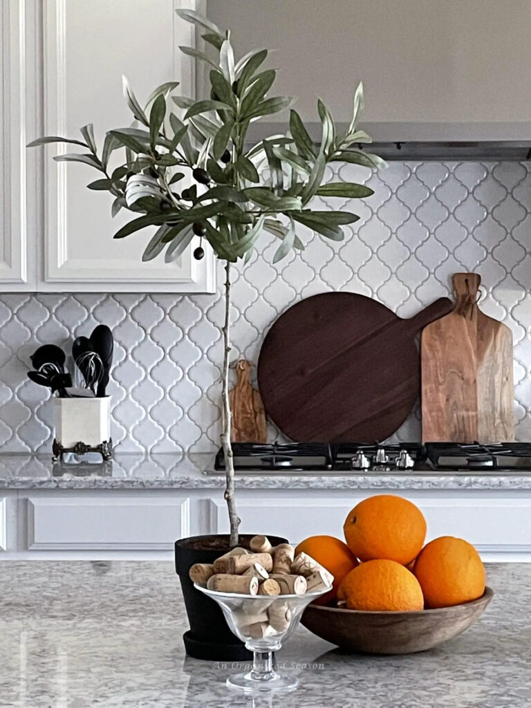 diy olive topiary on kitchen counter with oranges