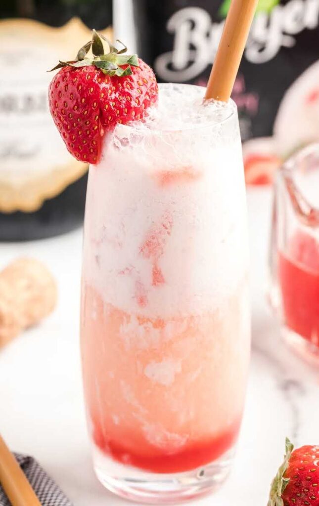 Strawberry Champagne float in a glass, garnished with a strawberry