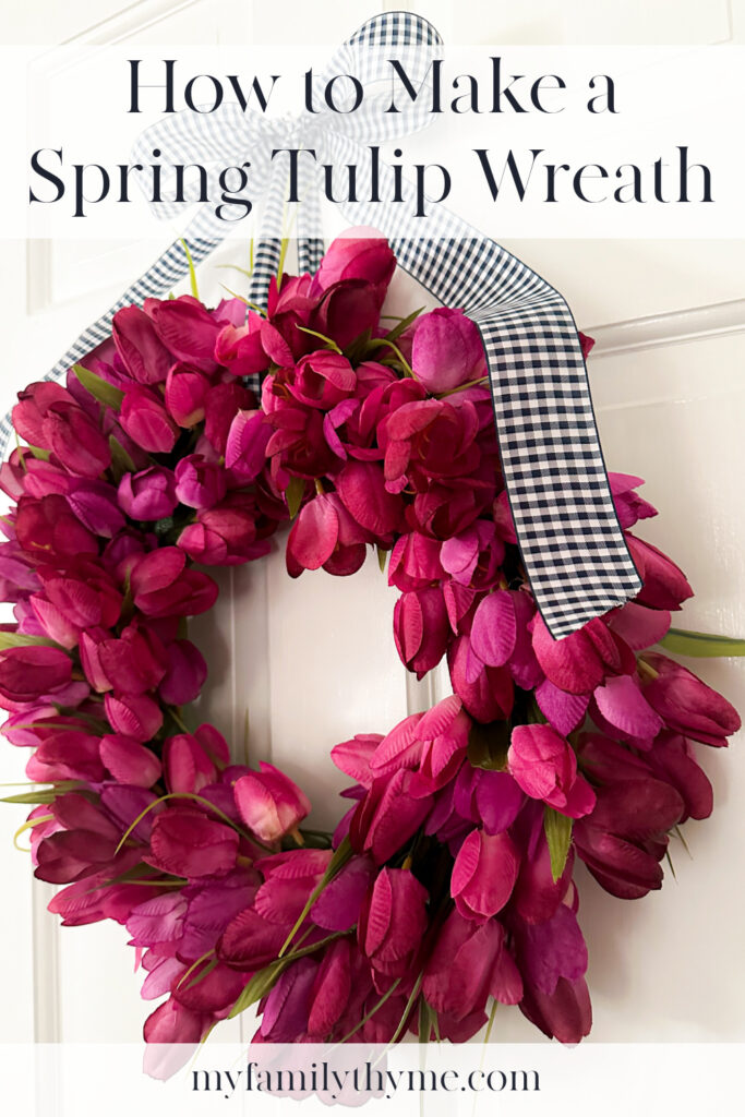 faux spring tulip wreath made with fuchsia faux tulips hanging on a white door.
