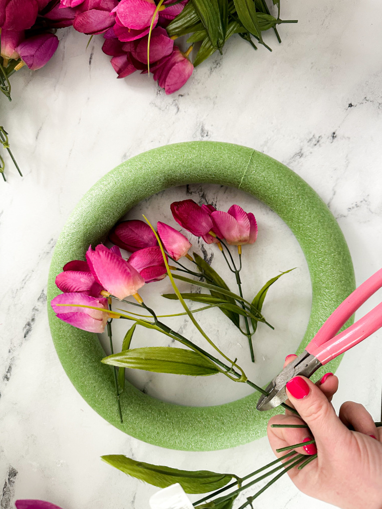 trimming faux fuchsia tulip stems with wire cutters