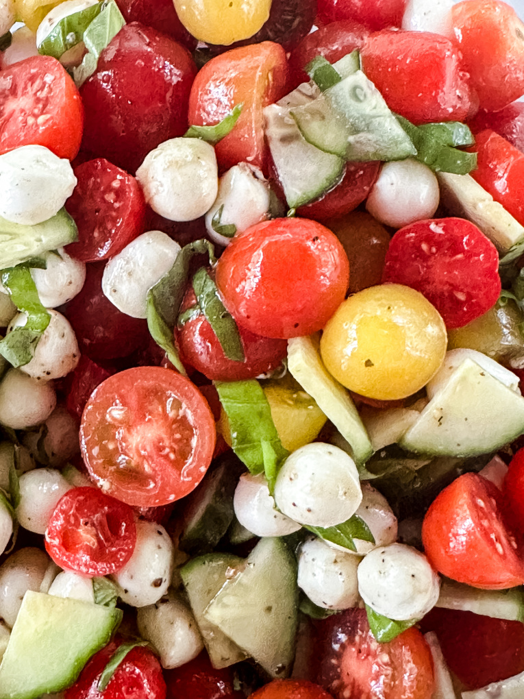 close up of tomato and mozzarella salad with cucumbers