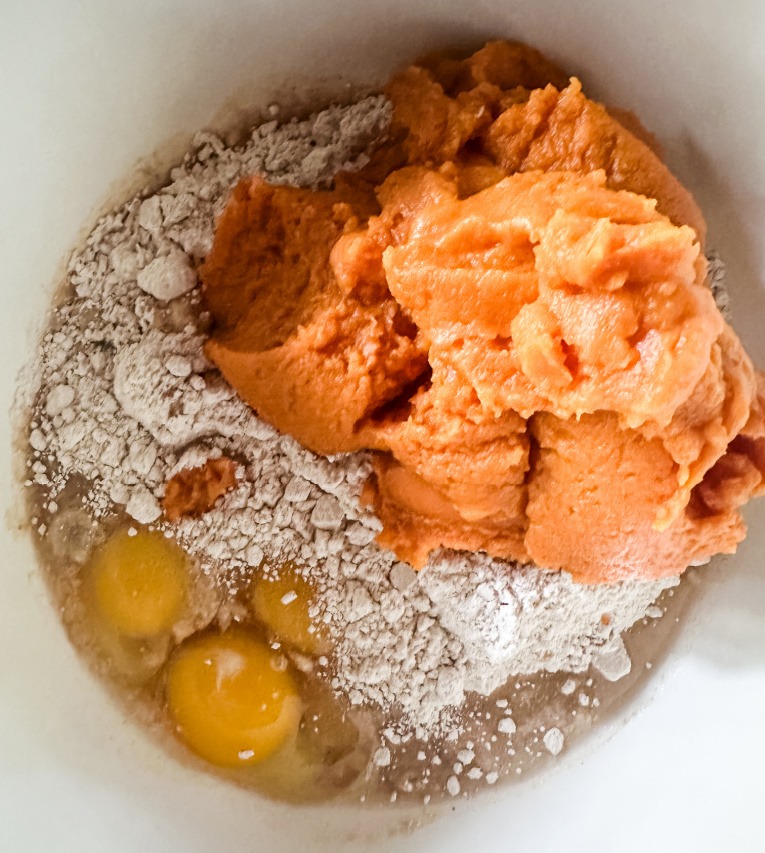 spice cake mix, eggs, water, and pumpkin puree in mixing bowl