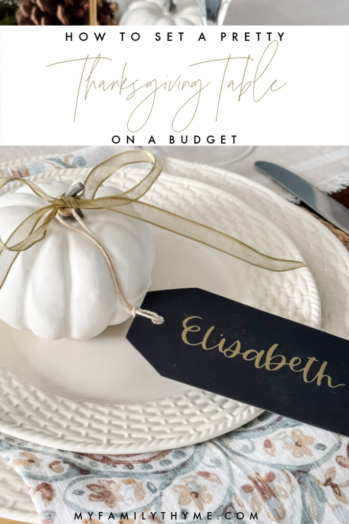 white pumpkin on plate with gold ribbon and black tag with Elisabeth printed in gold letters