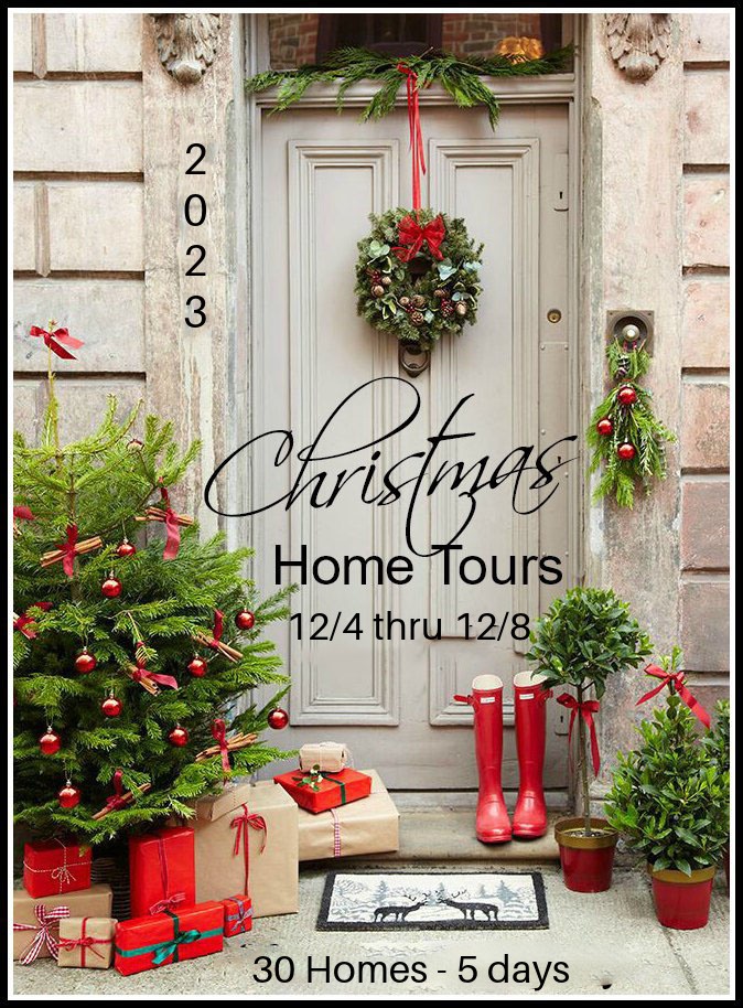 Exterior door decorated with traditional Christmas greens and red accents.
