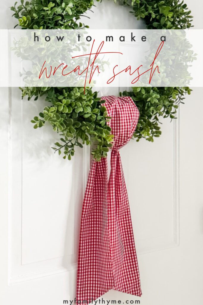 red and white gingham wreath sash on boxwood wreath hung on white interior door