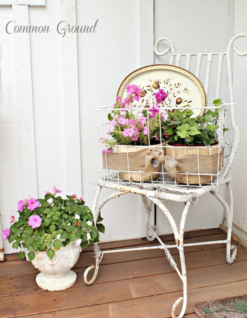pink and white impatiens planted in tureen and displayed on white vintage metal chair